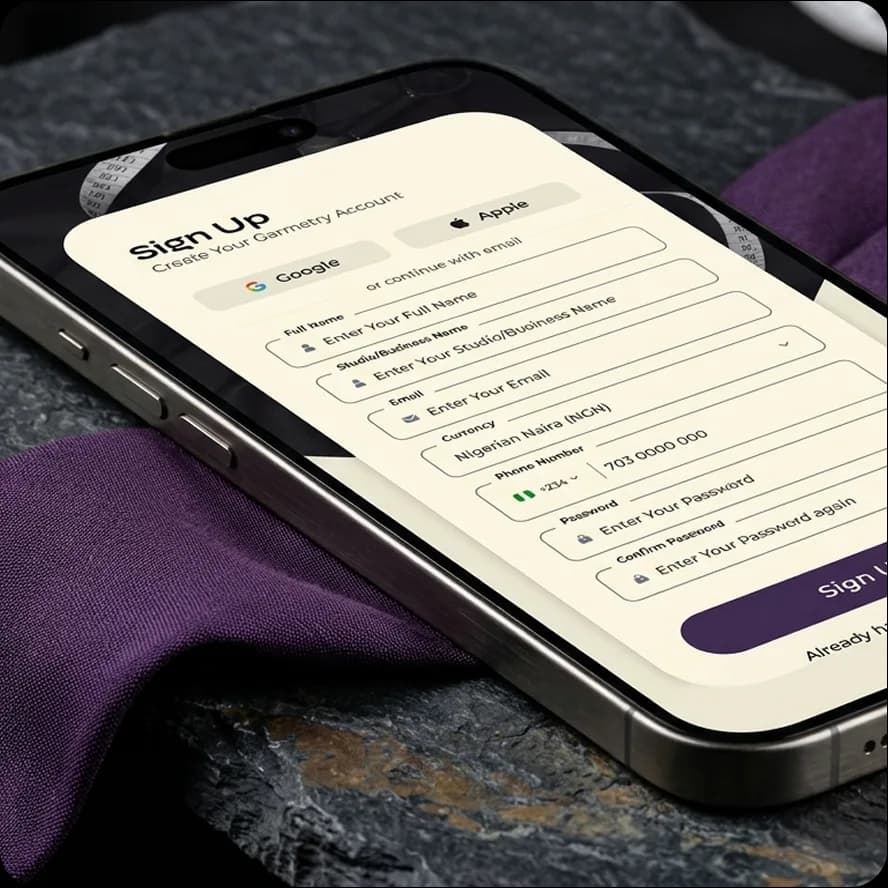 Garmetry sign-up screen on a phone resting on slate and purple fabric